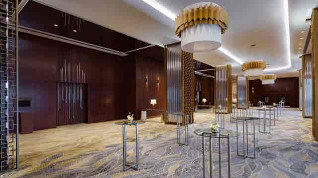 Luxury hotel ballroom pre-function space for corporate networking events and receptions.