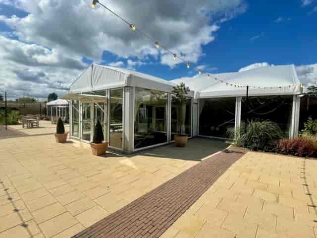 Bothy Gallery marquee with bistro lighting for corporate receptions and garden events.