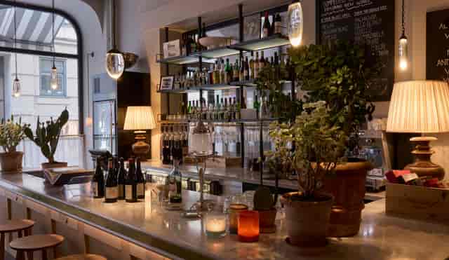 Hotel Villa Dagmar bar, warm ambient lighting, upscale networking event, VIP reception space.