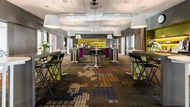 Grand Slam breakout space with high-top tables for networking and corporate events.