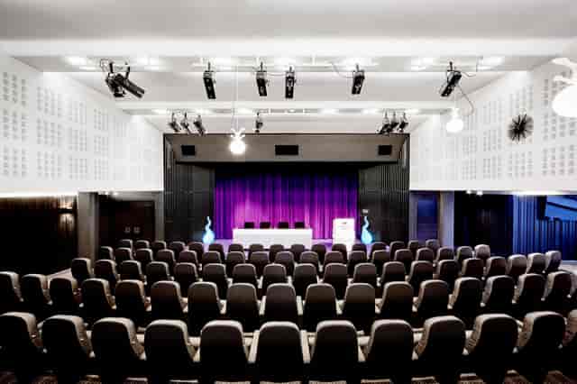 Piazzan auditorium in Stockholm with purple stage for corporate keynotes and professional events.