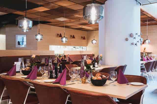 Upscale World Trade Center Stockholm luncheon venue with warm wood tones for corporate events.