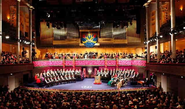 Stockholm Concert Hall awards ceremony featuring a multi-tiered stage and floral event decor.