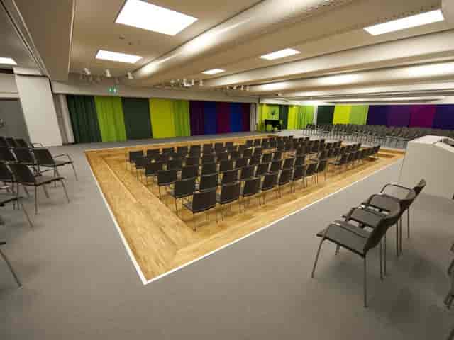 Theater-style conference room at Hotel Birger Jarl with colorful backdrop for event rental.
