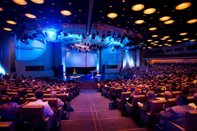 Plenary session in a tiered Life City auditorium for corporate conferences and business events.