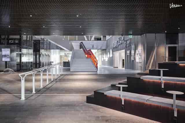 Modern Life City conference atrium with tiered seating for event registration and networking.