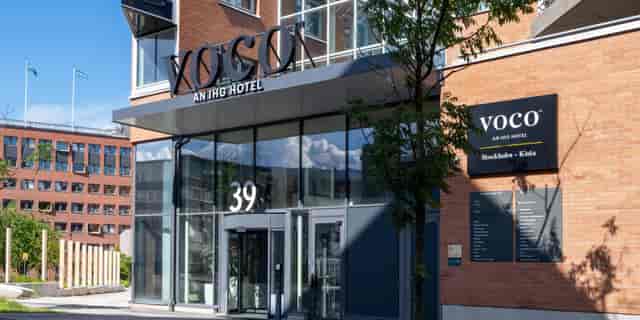 Modern entrance of voco Stockholm-Kista hotel, ideal for corporate events and delegate check-ins.