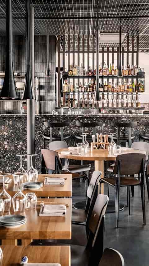 Modern bar with textured stone countertop for VIP dinners and networking events.