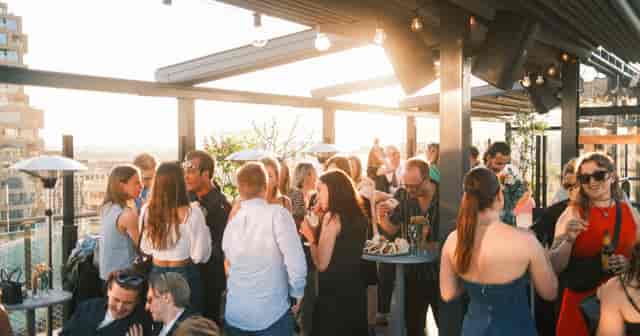 Rooftop networking reception at 12th Floor Bar featuring golden hour lighting for corporate events.