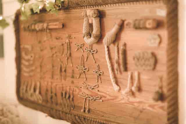 Rustic nautical rope-knot display board for maritime-themed event decor.