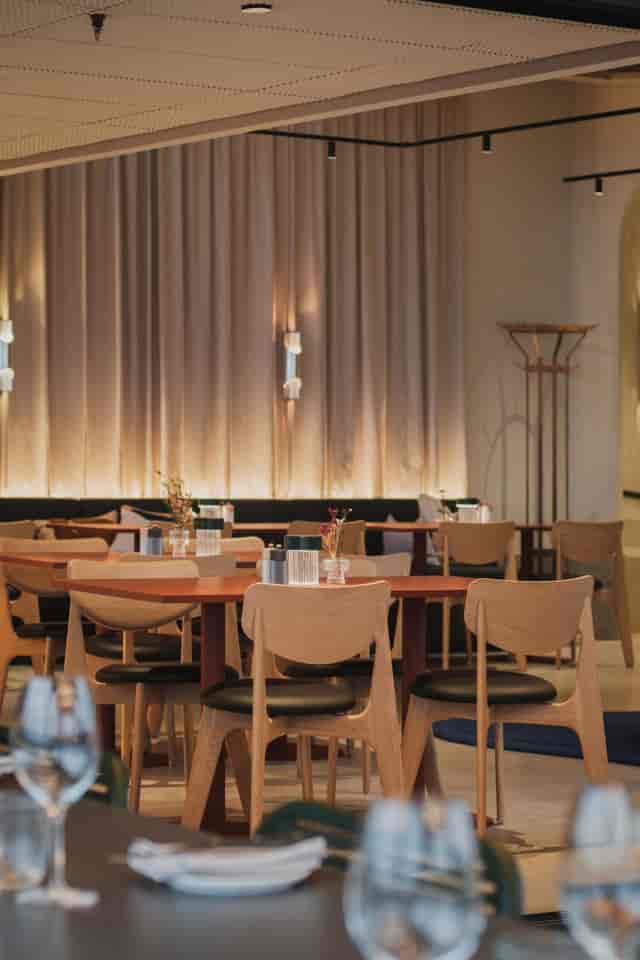 Upscale cafeteria with minimalist furniture for networking lunch or corporate breakout session.