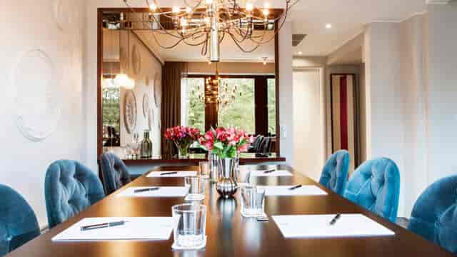 Luxury boardroom with plush velvet seating for executive strategy sessions and corporate meetings.