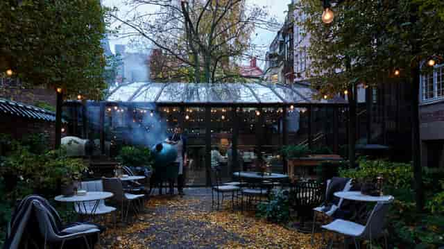Ett Hem Stockholm garden glass pavilion with live grilling station for luxury outdoor events.