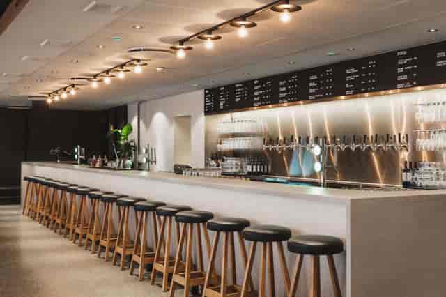 Contemporary bar at Scandic Malmen with tiered seating, ideal for networking and corporate events.