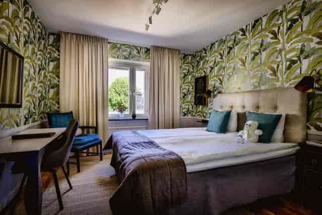 Boutique hotel room with workspace for corporate meetings and business travel events.