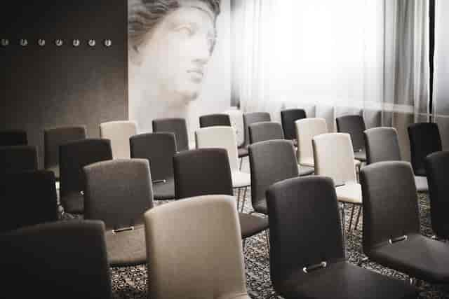 Theater-style conference room at Hotel Lilla Rådmannen with neoclassical mural for corporate events.