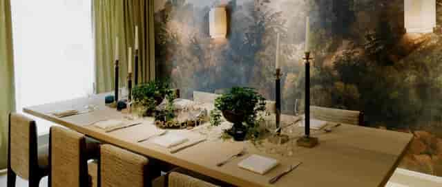 Upscale private dining at Villa Dahlia with mural backdrop, ideal for boardroom or corporate events.