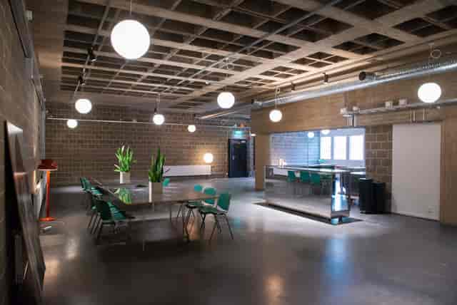 Industrial-chic workshop venue with exposed ceiling for networking events.