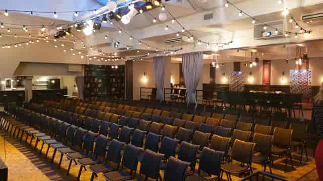 Industrial-chic Main Hall at VENUE81 with bistro lighting for corporate events and social gatherings.