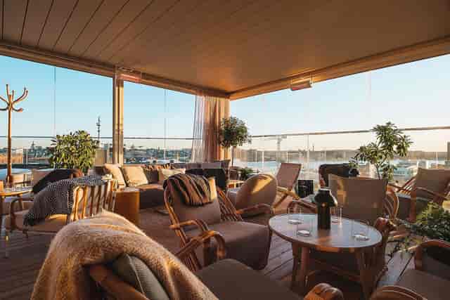 Rooftop bar with lounge seating for VIP networking and corporate reception events.