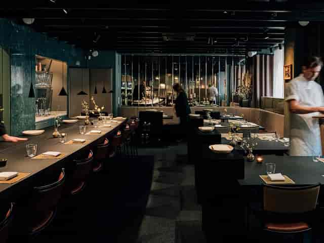 Private dining room at Matbaren featuring sleek, moody decor for exclusive corporate events.