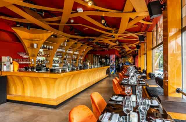 Stylish restaurant interior at Apollo Hotel Amsterdam, ideal for events, with modern wooden bar.