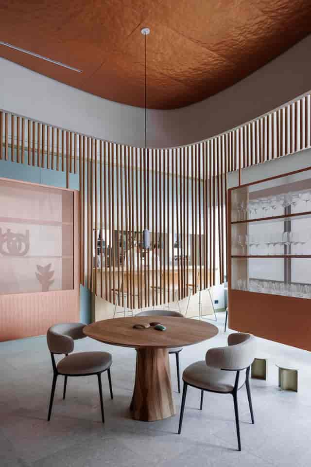 Sophisticated semi-private dining area with slat partitions, ideal for VIP events and networking.