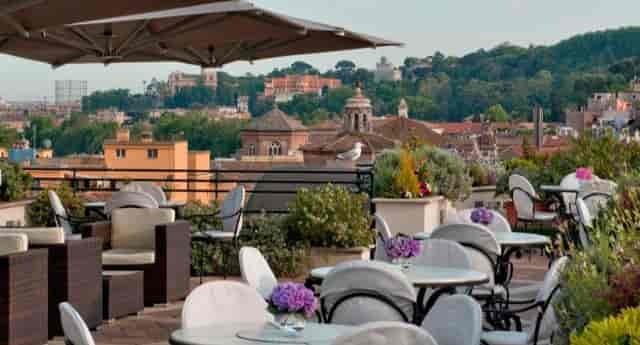 Rooftop garden venue in Rome with panoramic skyline for cocktail receptions and networking events.