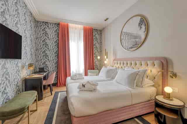 Luxury H10 Palazzo Galla boutique guest room with workspace for executive corporate travel.