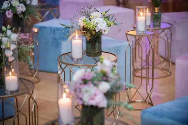 Velvet ottomans and gold tables in a Rome garden, ideal for sophisticated cocktail networking events.