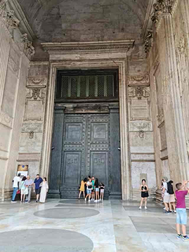 Pantheon entrance with massive historic doors for exclusive gala and red-carpet event venue.