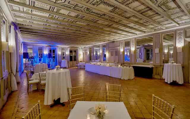 Sala degli Specchi event space with blue uplighting for elegant evening galas and receptions.