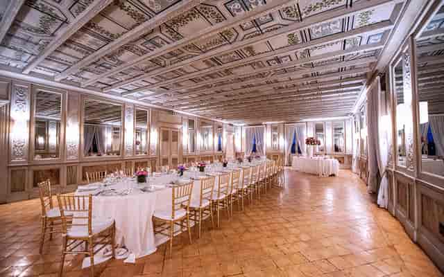 Historic Casina Valadier banquet hall with long tables for luxury gala or executive dinner.