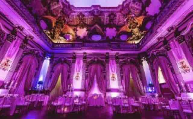 Galleria degli Specchi gala setup with dramatic architectural lighting for luxury event venue.