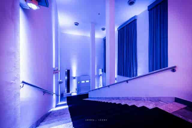 Spazio Novecento indoor terrace with blue lighting for evening receptions and product reveals.