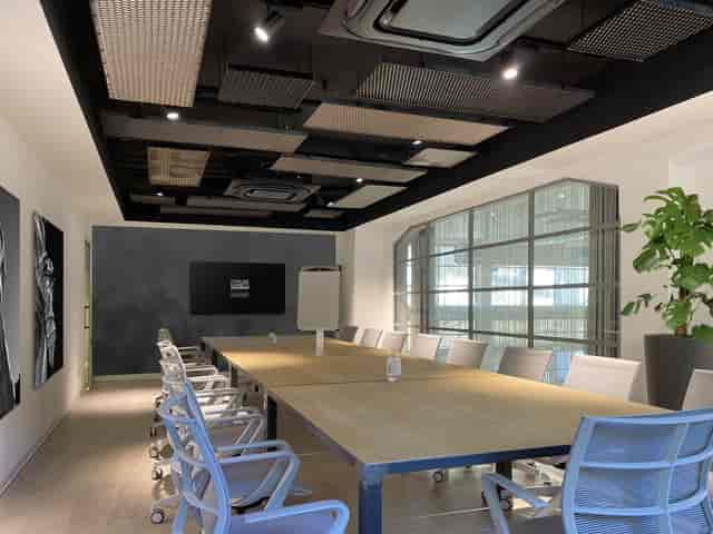 Modern boardroom at Officine Farneto with acoustic panels for corporate meetings and conferences.