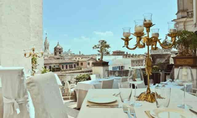 Luxury rooftop dinner at Terrazza Borromini featuring panoramic city views for incentive events.