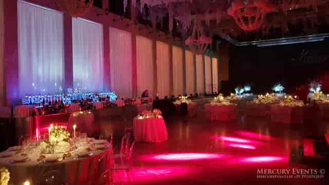 Gala event setup in Salone delle Fontane with dramatic lighting and draped architecture.