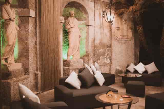 Gatsby Lounge: VIP networking event space with classical statues and modern modular seating.