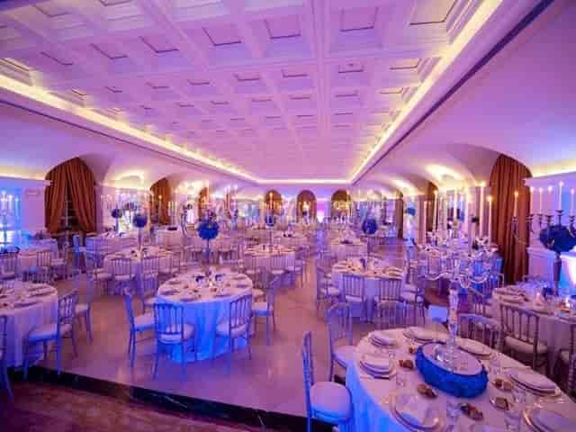 Villa Miani ballroom with violet lighting and candelabras for a luxury wedding or gala event.