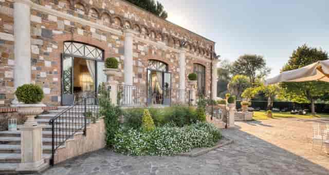 Historic stone ballroom at Nuova Villa dei Cesari: elegant outdoor venue for weddings and retreats.