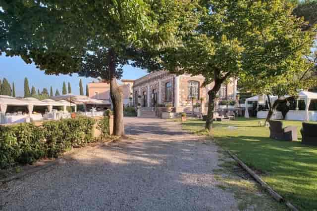 Ancient Ballroom venue with tented layout for luxury outdoor weddings and corporate retreats.