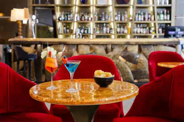 Upscale piano bar with velvet chairs for VIP networking and corporate cocktail reception events.