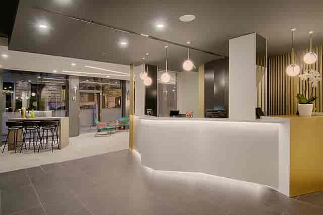Modern hotel lobby and bar with sleek reception desk for corporate events and networking.