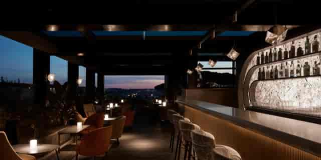 Luxury rooftop bar in Rome, ideal for VIP receptions and executive networking events at sunset.