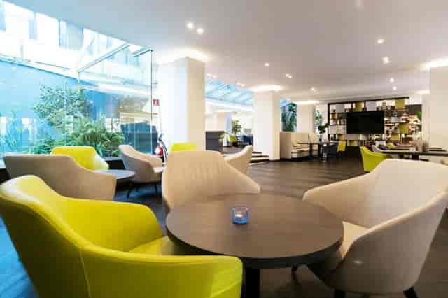 Modern hotel lobby lounge at Mercure Eur Roma West, ideal for business networking and meetings.