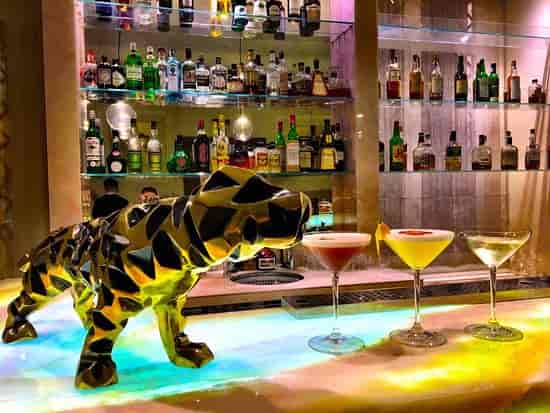 Upscale hotel bar with sculptural centerpiece for VIP receptions and cocktail events.