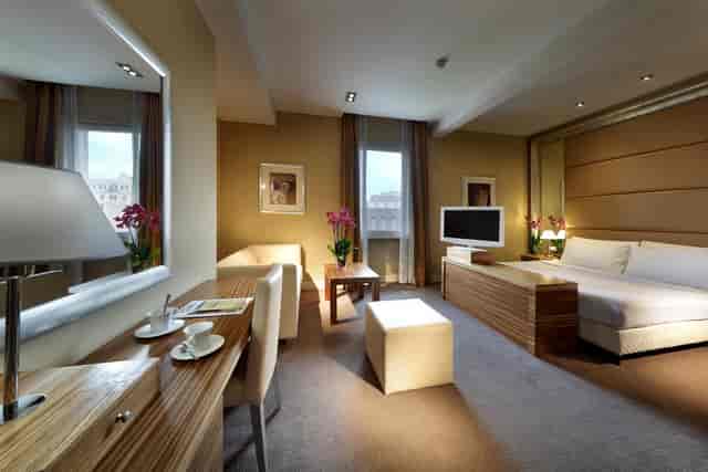 Executive hotel meeting room with dedicated workspace for corporate events and business travel.
