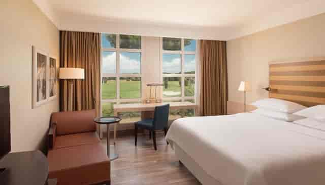 Sheraton Rome hotel room with workspace for business travel and corporate event accommodation.