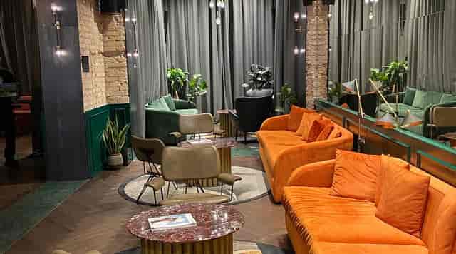 Networking cafe in Chapter Roma with conversational seating pods for professional events.